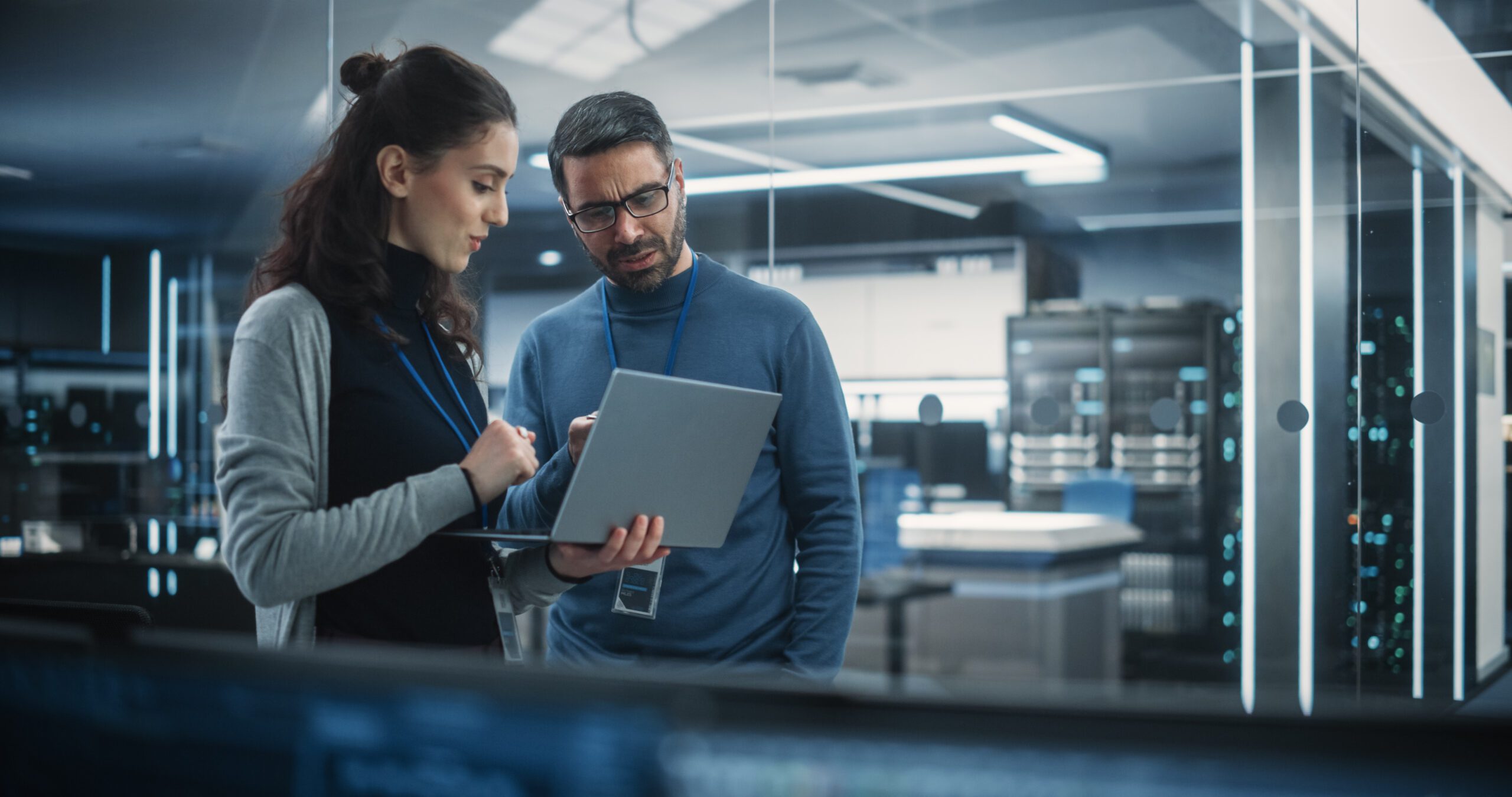 Portrait of Two Female and Male Engineers Using Laptop Computer BITS GmbH