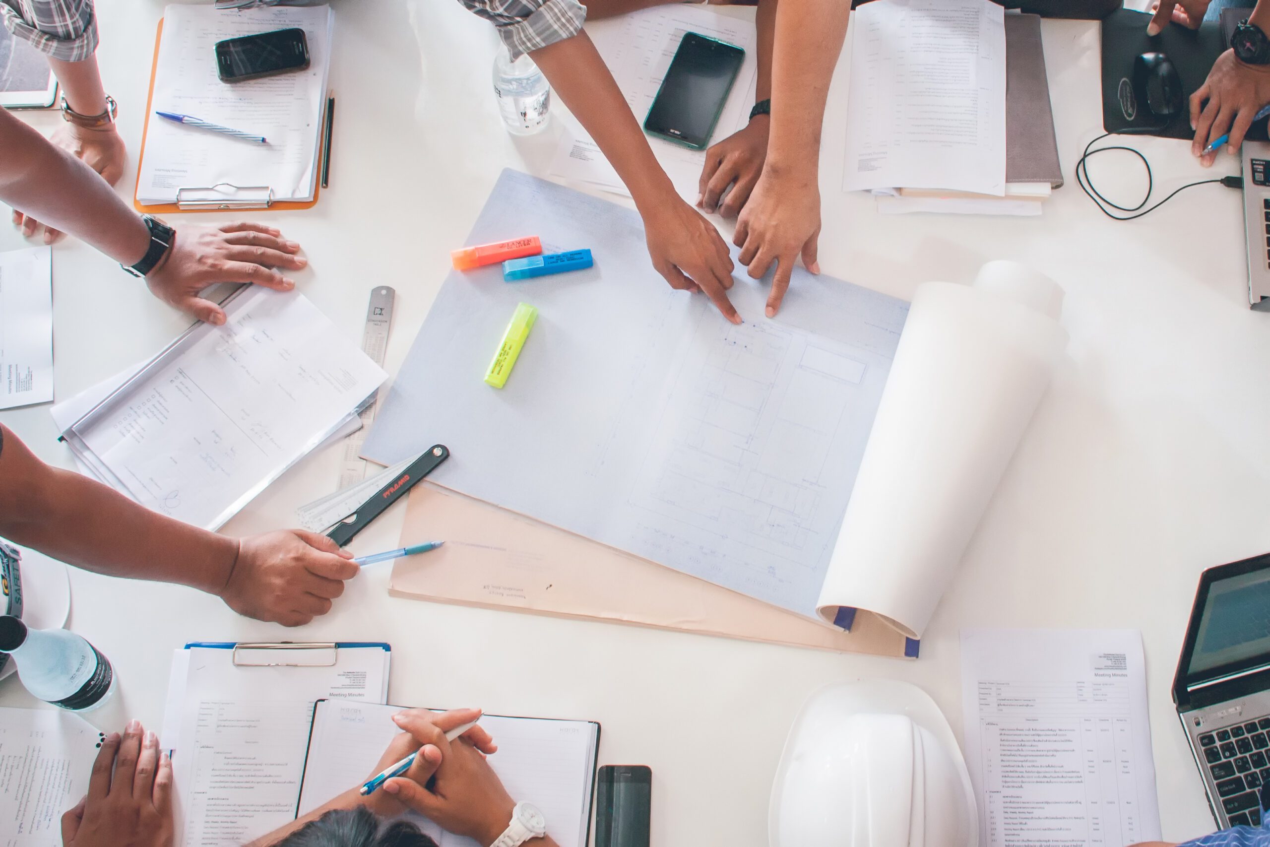 Team of architects people in group on construciton site check do